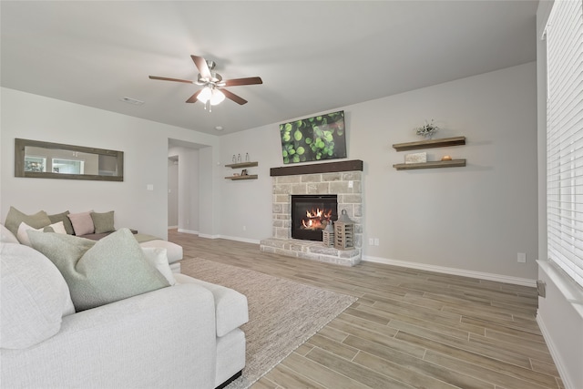 1420 Whitetail Ln, Azle, TX 76020 - living area featuring a ceiling fan, wood finished floors, and a stone fireplace