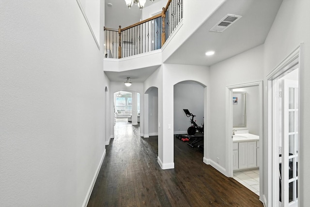 4336 Westminster Ave, Celina, TX 76227 - hallway featuring arched walkways, wood finished floors, and a towering ceiling