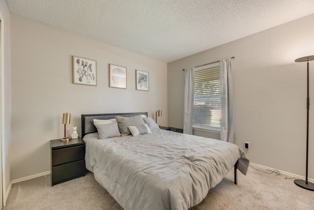1833 Alonsdale Dr, Garland, TX 75040 - carpeted bedroom with a textured ceiling and baseboards
