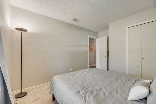 1833 Alonsdale Dr, Garland, TX 75040 - carpeted bedroom with a textured ceiling and a closet