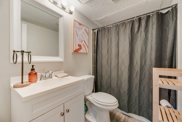 1833 Alonsdale Dr, Garland, TX 75040 - bathroom with a textured ceiling, vanity, wood finished floors, and a shower with shower curtain