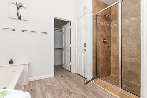 1918 Palace Dr, Grand Prairie, TX 75050 - full bathroom with a stall shower, a garden tub, and wood finished floors