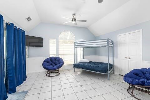 1918 Palace Dr, Grand Prairie, TX 75050 - bedroom with lofted ceiling, light tile patterned floors, a ceiling fan, and a closet