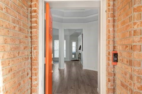 1918 Palace Dr, Grand Prairie, TX 75050 - hallway with dark wood-style floors and brick wall