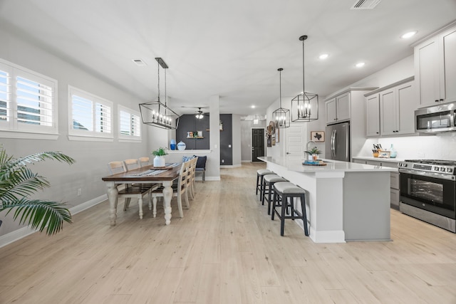 2102 Clearwater Way, Royse City, TX 75189 - kitchen with stainless steel appliances, a chandelier, a breakfast bar area, light countertops, and recessed lighting
