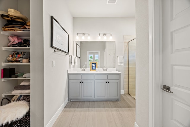 2102 Clearwater Way, Royse City, TX 75189 - bathroom with a shower stall, wood finished floors, and double vanity