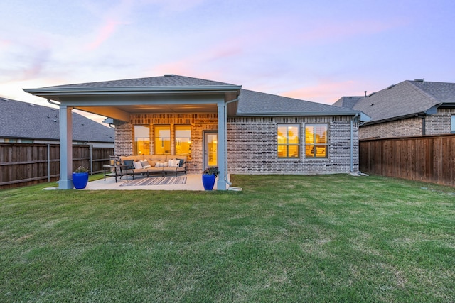 2102 Clearwater Way, Royse City, TX 75189 - back of house at dusk featuring an outdoor hangout area, brick siding, a fenced backyard, and a patio