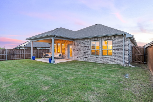 2102 Clearwater Way, Royse City, TX 75189 - back of property at dusk featuring brick siding, a fenced backyard, outdoor lounge area, a patio, and roof with shingles