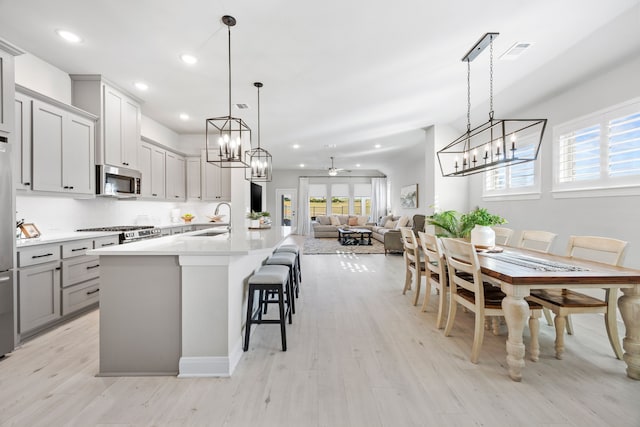 2102 Clearwater Way, Royse City, TX 75189 - kitchen featuring plenty of natural light, light wood-type flooring, stainless steel microwave, open floor plan, and recessed lighting
