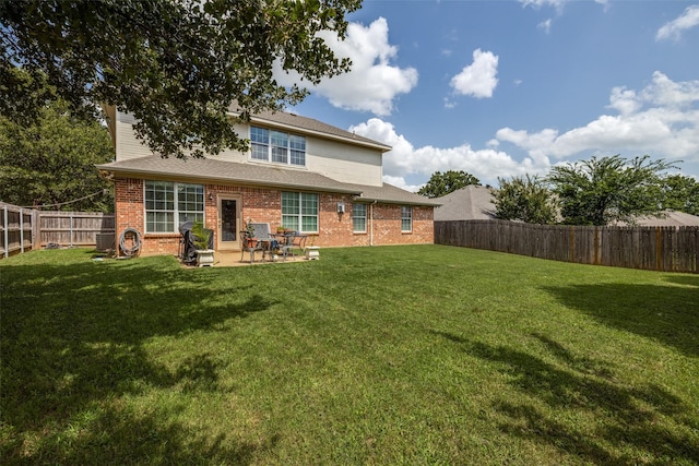 701 Parkhill Dr, Mansfield, TX 76063 - rear view of property featuring brick siding, a fenced backyard, a patio area, and roof with shingles