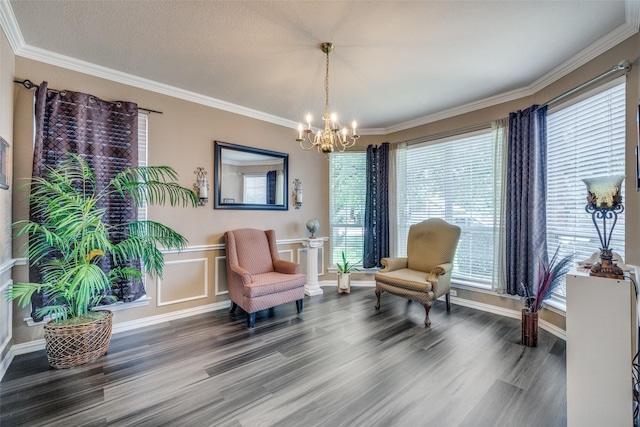 701 Parkhill Dr, Mansfield, TX 76063 - living area with a chandelier, wood finished floors, crown molding, and a wainscoted wall