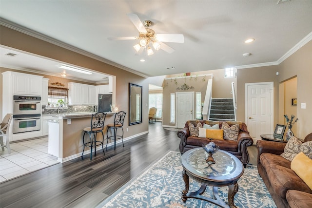 701 Parkhill Dr, Mansfield, TX 76063 - living room featuring stairway, light wood-style flooring, crown molding, ceiling fan, and recessed lighting