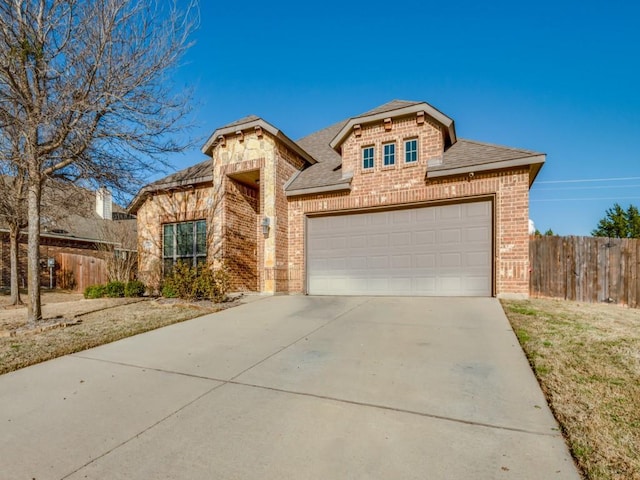 1314 Greenrock Ct, Midlothian, TX 76065 - view of front of property with brick siding, driveway, roof with shingles, an attached garage, and stone siding