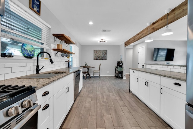 4716 Everest Dr, Fort Worth, TX 76132 - kitchen featuring decorative backsplash, open shelves, appliances with stainless steel finishes, pendant lighting, and light stone countertops