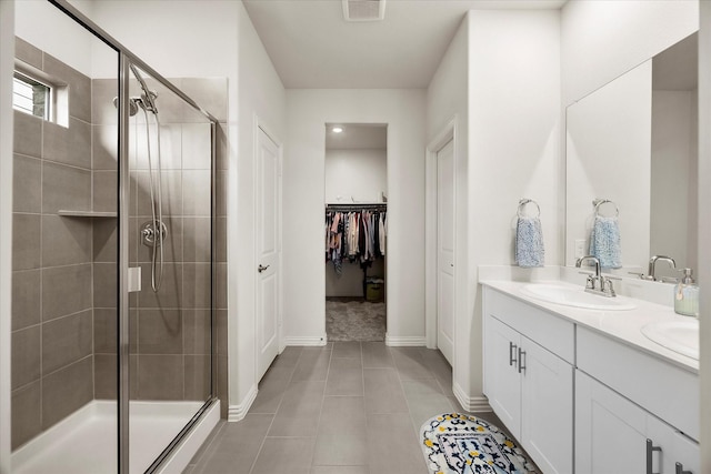 5223 Amistad Ave, Royse City, TX 75189 - bathroom with a stall shower, double vanity, a walk in closet, and tile patterned floors
