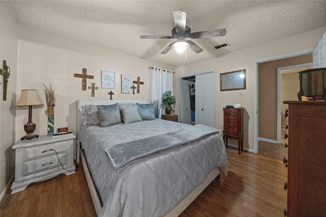 6753 Murphy St, Murchison, TX 75778 - bedroom with wood finished floors, a closet, a textured ceiling, and a ceiling fan