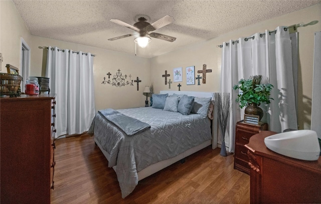 6753 Murphy St, Murchison, TX 75778 - bedroom featuring wood finished floors, a textured ceiling, and a ceiling fan