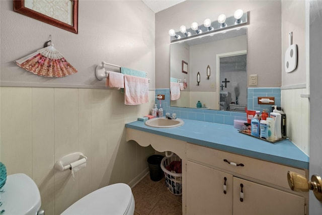 6753 Murphy St, Murchison, TX 75778 - bathroom featuring tile patterned floors, tile walls, a wainscoted wall, and vanity