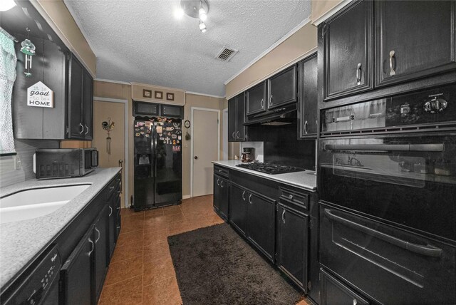6753 Murphy St, Murchison, TX 75778 - kitchen featuring black fridge with ice dispenser, dark cabinets, gas stovetop, under cabinet range hood, and a textured ceiling