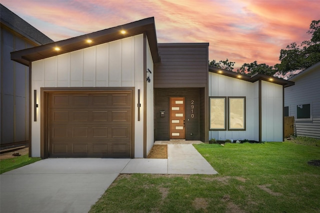 2910 Brigham Ln, Dallas, TX 75215 - modern home featuring board and batten siding, an attached garage, driveway, and a front lawn