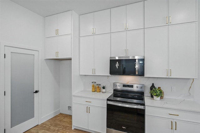 2910 Brigham Ln, Dallas, TX 75215 - kitchen with appliances with stainless steel finishes, white cabinets, light wood finished floors, and light stone counters