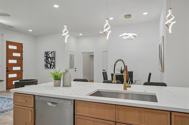 2910 Brigham Ln, Dallas, TX 75215 - kitchen with stainless steel dishwasher, hanging light fixtures, recessed lighting, light stone countertops, and light wood finished floors