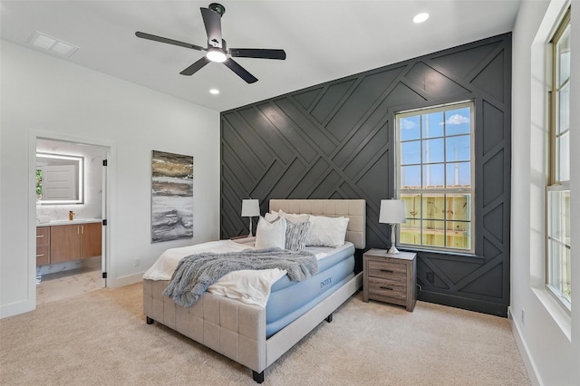 2910 Brigham Ln, Dallas, TX 75215 - bedroom featuring light colored carpet, an accent wall, recessed lighting, ensuite bath, and ceiling fan