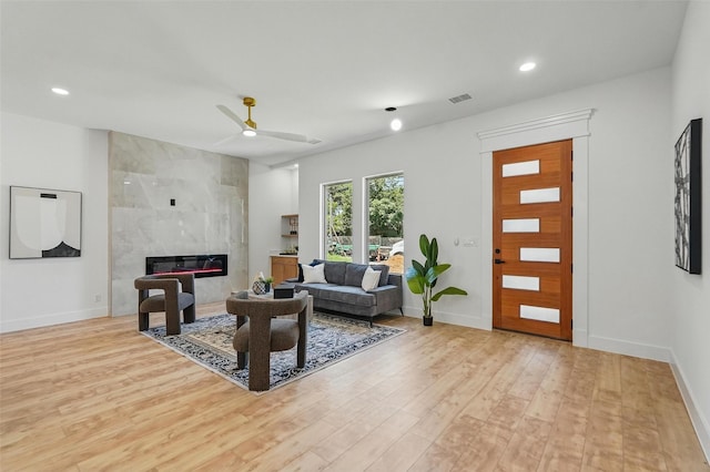 2910 Brigham Ln, Dallas, TX 75215 - living room with light wood-style flooring, a ceiling fan, recessed lighting, and a high end fireplace
