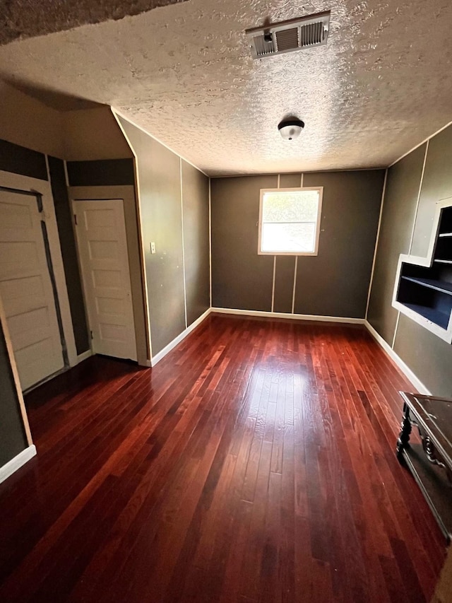 1612 Lagonda Ave, Fort Worth, TX 76164 - unfurnished bedroom featuring wood-type flooring and a textured ceiling