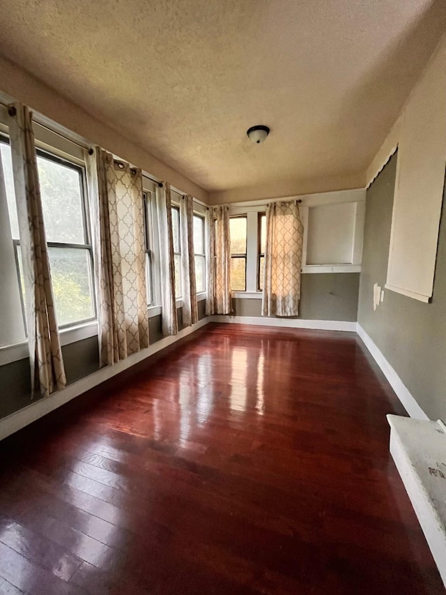 1612 Lagonda Ave, Fort Worth, TX 76164 - unfurnished living room featuring a textured ceiling and hardwood / wood-style floors