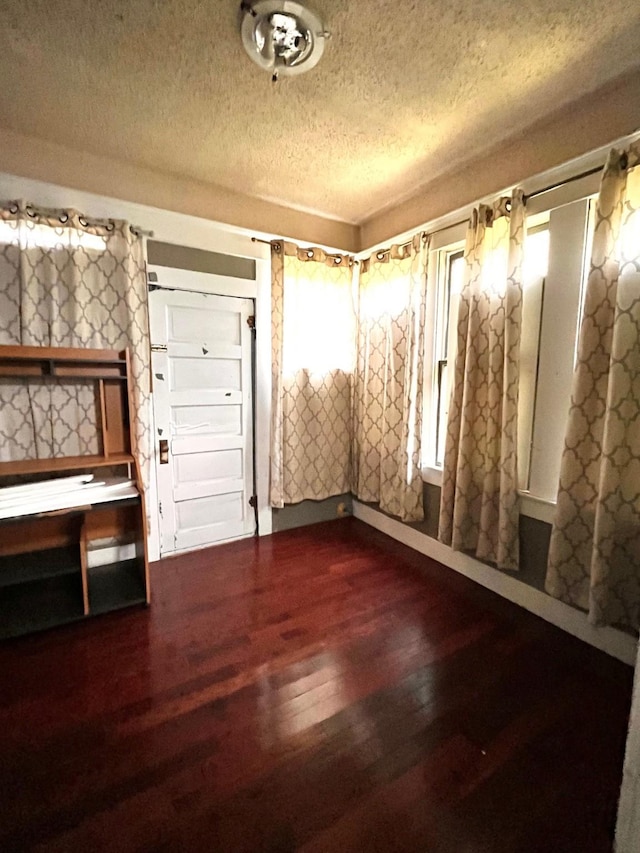1612 Lagonda Ave, Fort Worth, TX 76164 - empty room with a textured ceiling and wood finished floors