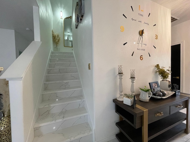 1603 Pacific Ave, Ennis, TX 75119 - staircase featuring marble look tile flooring and baseboards
