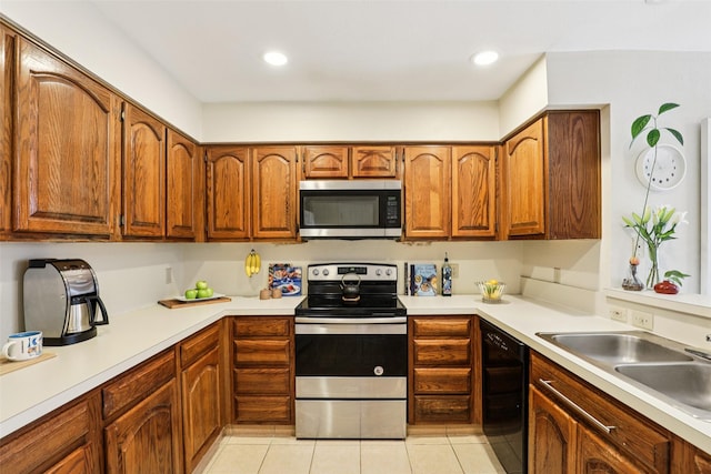 2531 Stanford Ct, Carrollton, TX 75006 - kitchen featuring appliances with stainless steel finishes, light countertops, brown cabinetry, light tile patterned flooring, and recessed lighting