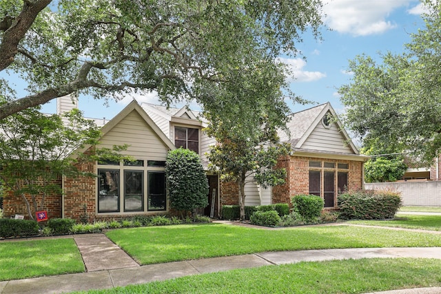 2531 Stanford Ct, Carrollton, TX 75006 - view of property hidden behind natural elements featuring brick siding and a front yard