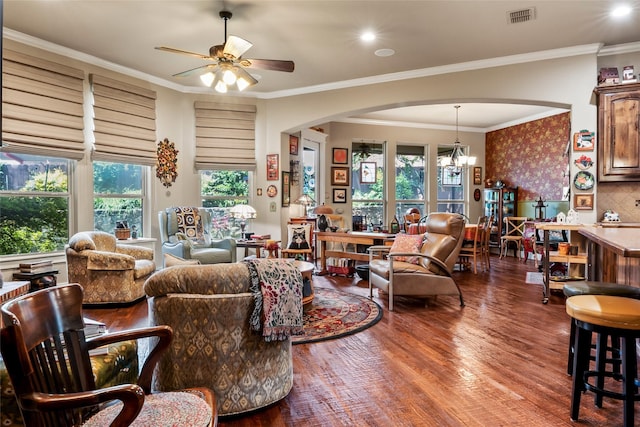 513 Hearth Ter, Argyle, TX 76226 - living area featuring arched walkways, ceiling fan, wood finished floors, a chandelier, and crown molding