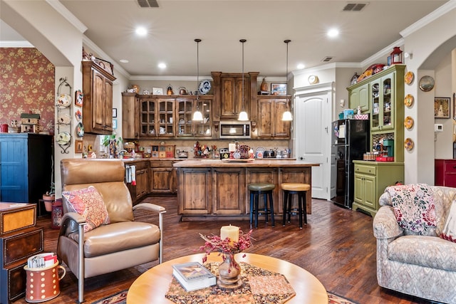 513 Hearth Ter, Argyle, TX 76226 - living area featuring dark wood finished floors, crown molding, recessed lighting, and arched walkways