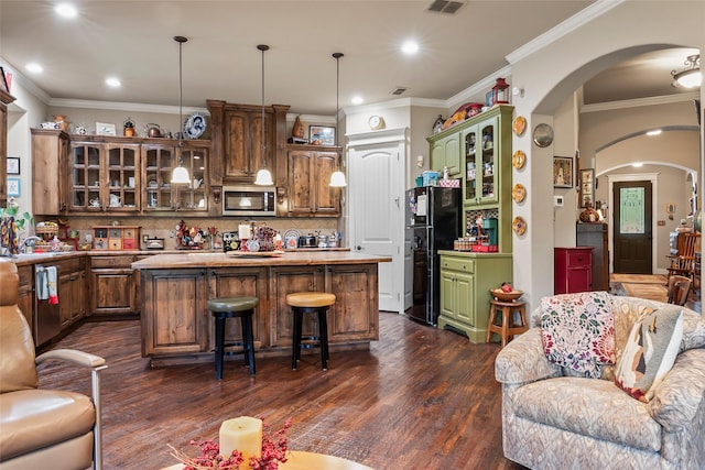 513 Hearth Ter, Argyle, TX 76226 - kitchen with stainless steel appliances, arched walkways, dark wood finished floors, a kitchen island, and glass insert cabinets