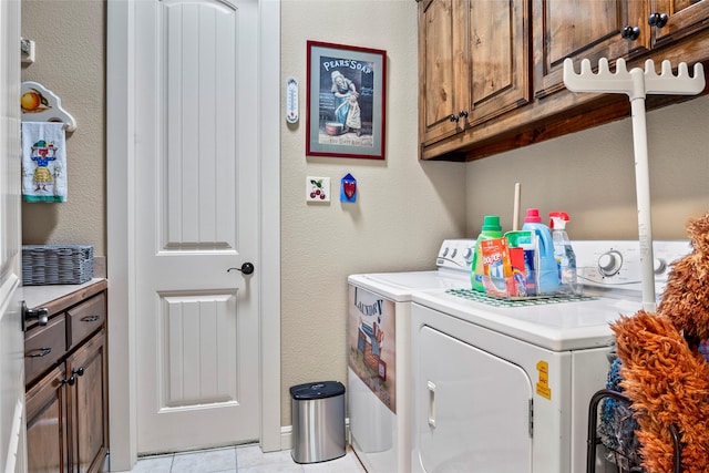 513 Hearth Ter, Argyle, TX 76226 - laundry area with independent washer and dryer, cabinet space, a textured wall, and light tile patterned floors