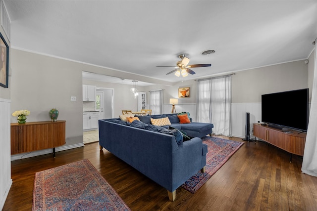 3829 Byers Ave, Fort Worth, TX 76107 - living room featuring healthy amount of natural light, a ceiling fan, dark wood-type flooring, wainscoting, and ornamental molding