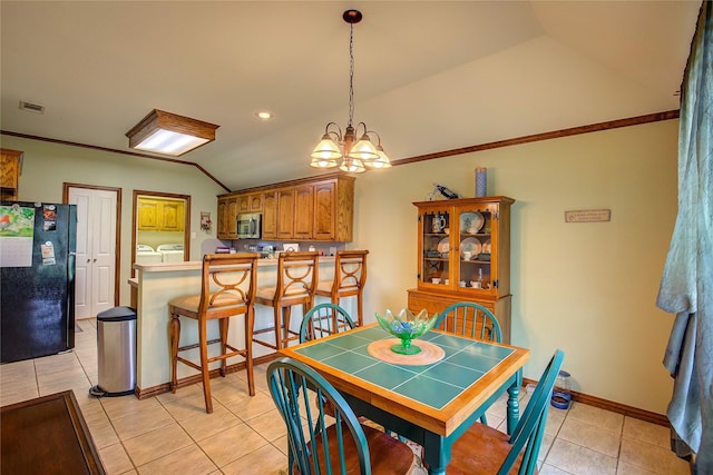 1813 Ranch Rd, Royse City, TX 75189 - dining area with washing machine and clothes dryer, lofted ceiling, light tile patterned floors, and a chandelier