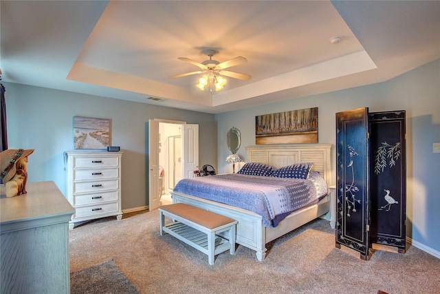 1813 Ranch Rd, Royse City, TX 75189 - bedroom with a tray ceiling, light carpet, ceiling fan, and connected bathroom