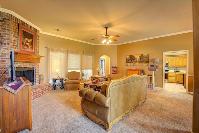 1813 Ranch Rd, Royse City, TX 75189 - living room with light carpet, arched walkways, a brick fireplace, a ceiling fan, and ornamental molding