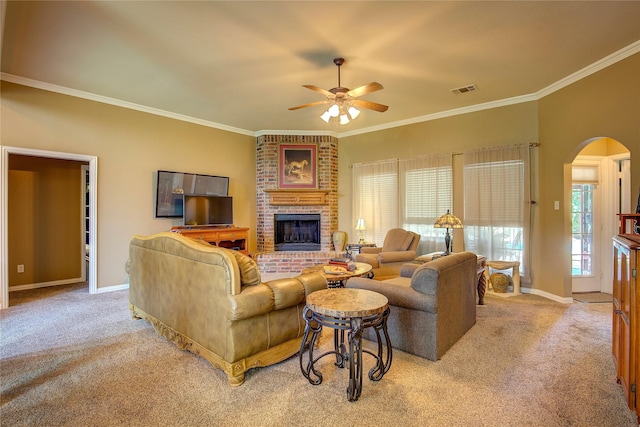1813 Ranch Rd, Royse City, TX 75189 - carpeted living area featuring arched walkways, ceiling fan, a brick fireplace, and crown molding