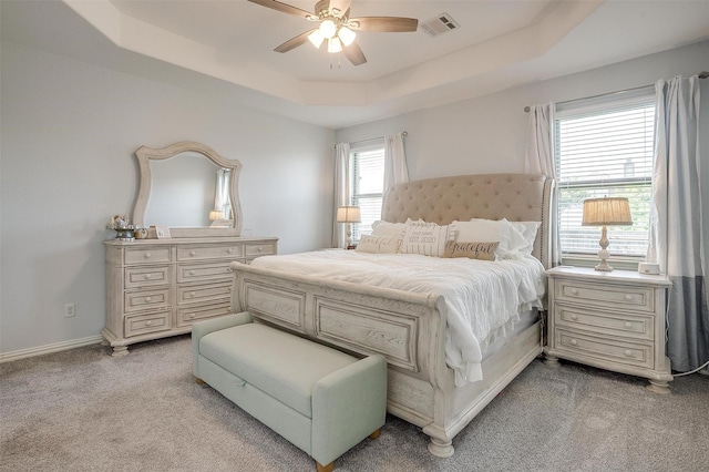 1148 Blue Sky Ln, Burleson, TX 76058 - bedroom featuring light carpet, a raised ceiling, and a ceiling fan