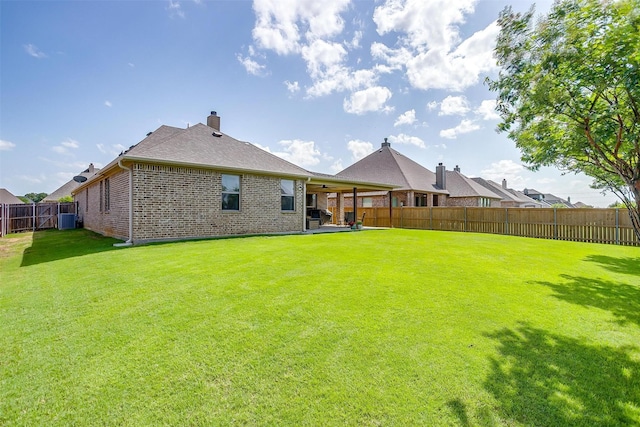 1148 Blue Sky Ln, Burleson, TX 76058 - back of property with a fenced backyard, brick siding, a chimney, and a patio area