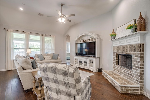1148 Blue Sky Ln, Burleson, TX 76058 - living room with ceiling fan, dark wood-type flooring, vaulted ceiling, arched walkways, and a fireplace