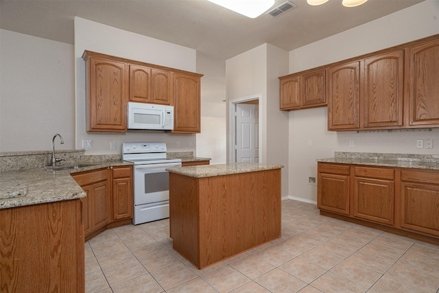 302 Howard Way Dr, Aledo, TX 76008 - kitchen with white appliances, light stone counters, a center island, and light tile patterned floors