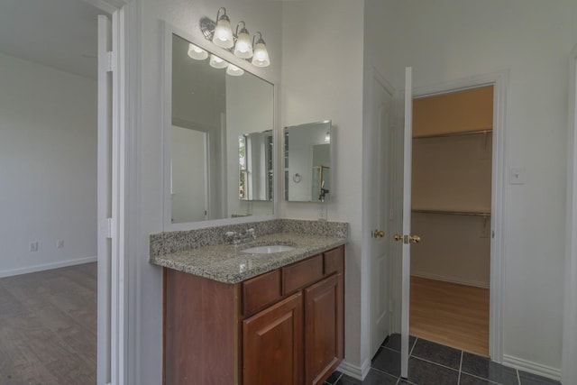 4600 Via Ventura, Mesquite, TX 75150 - bathroom featuring vanity, a spacious closet, and tile patterned floors
