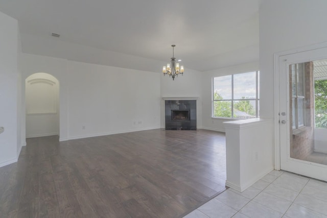 4600 Via Ventura, Mesquite, TX 75150 - unfurnished living room with a chandelier, light wood-style flooring, and a fireplace