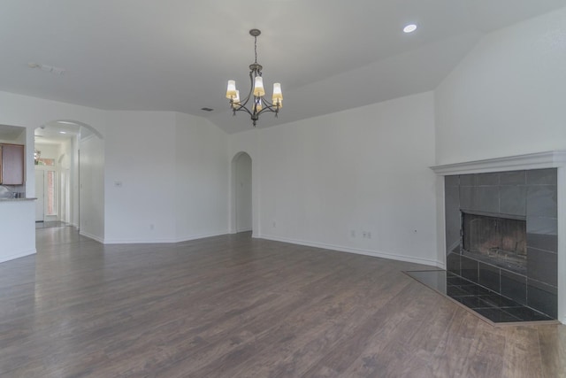 4600 Via Ventura, Mesquite, TX 75150 - unfurnished living room with arched walkways, vaulted ceiling, dark wood-style flooring, a chandelier, and a fireplace
